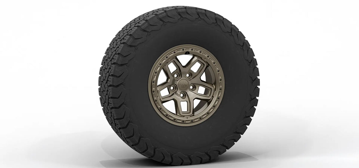 Tire with off-road tread pattern and metallic rim on a white background | Bronze Finish with Hardware Kit