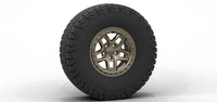 Tire with off-road tread pattern and metallic rim on a white background | Bronze Finish with Hardware Kit